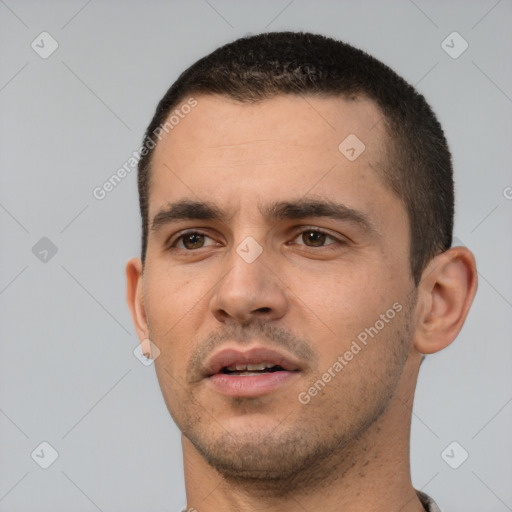 Neutral white young-adult male with short  black hair and brown eyes
