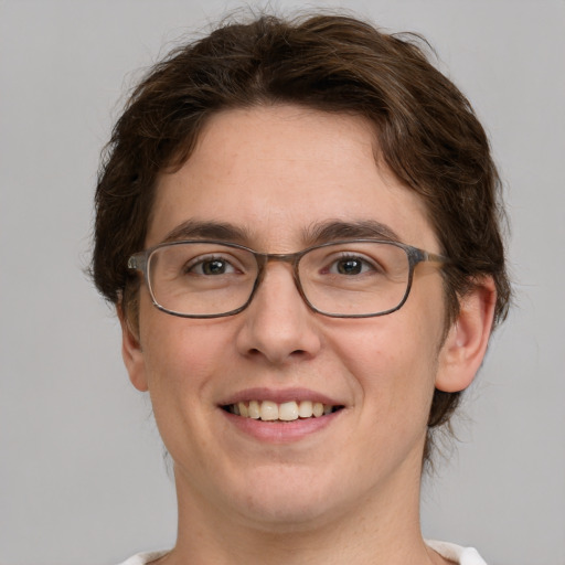 Joyful white adult male with medium  brown hair and green eyes