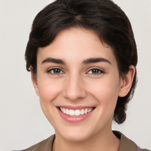 Joyful white young-adult female with medium  brown hair and brown eyes