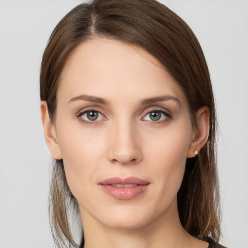 Joyful white young-adult female with long  brown hair and grey eyes