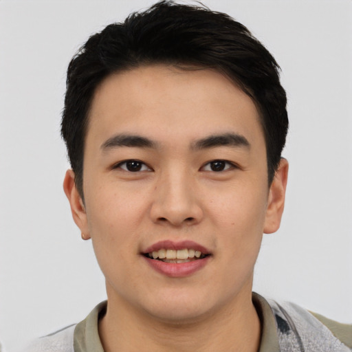 Joyful asian young-adult male with short  black hair and brown eyes