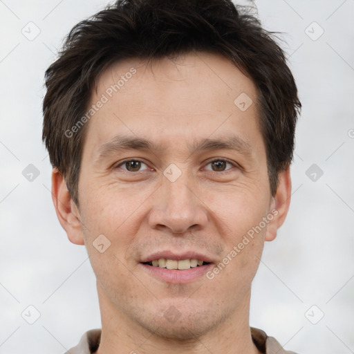 Joyful white adult male with short  brown hair and brown eyes