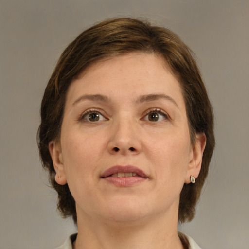 Joyful white adult female with medium  brown hair and brown eyes