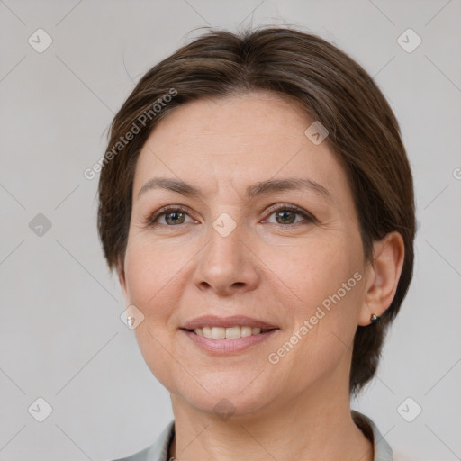 Joyful white adult female with medium  brown hair and grey eyes