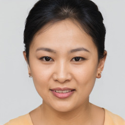 Joyful asian young-adult female with short  brown hair and brown eyes
