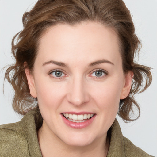 Joyful white young-adult female with medium  brown hair and blue eyes