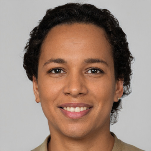 Joyful latino young-adult female with short  brown hair and brown eyes