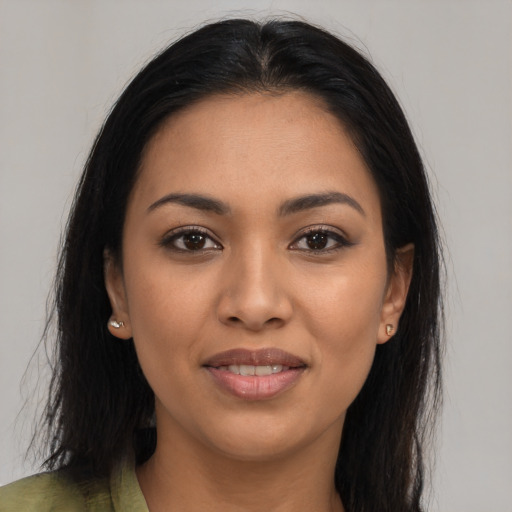 Joyful latino young-adult female with long  brown hair and brown eyes