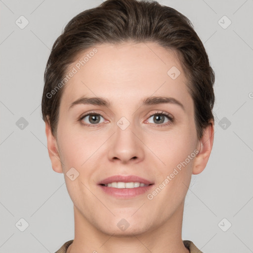 Joyful white young-adult female with short  brown hair and grey eyes