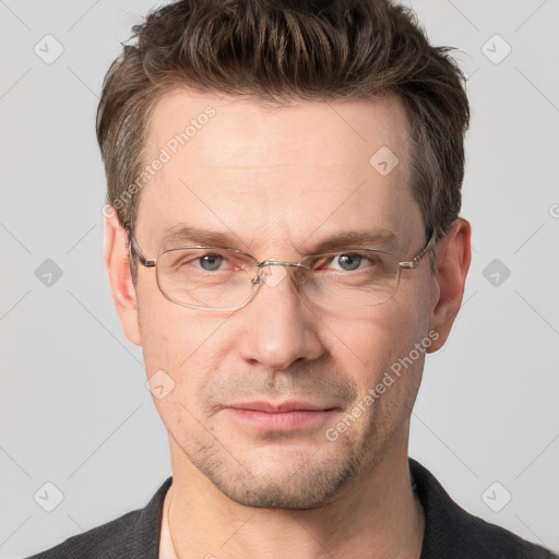 Joyful white adult male with short  brown hair and grey eyes