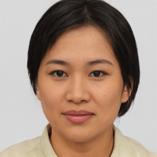 Joyful asian young-adult female with medium  brown hair and brown eyes