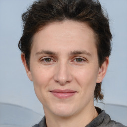 Joyful white adult female with short  brown hair and grey eyes