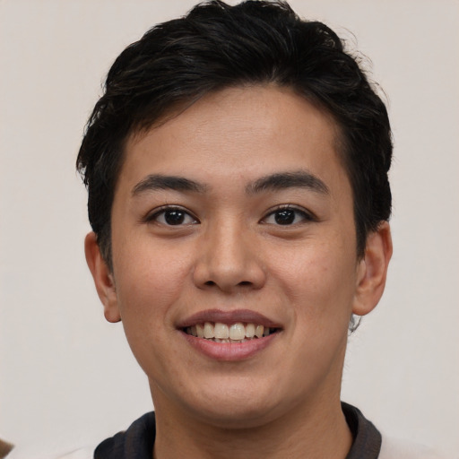 Joyful asian young-adult male with short  brown hair and brown eyes
