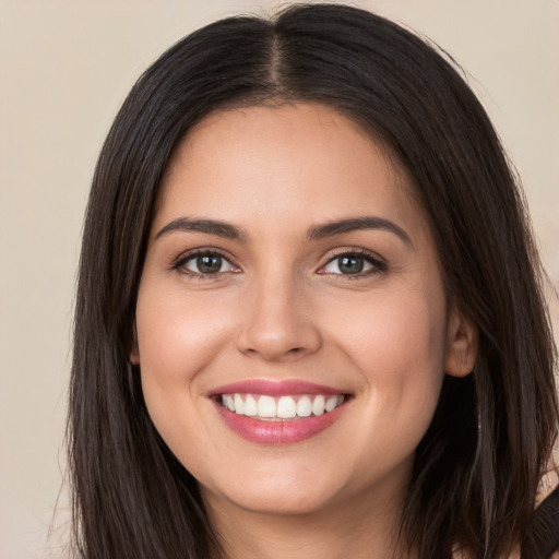 Joyful white young-adult female with long  brown hair and brown eyes