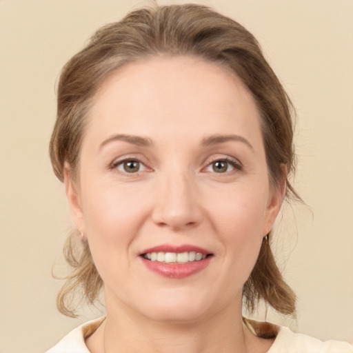 Joyful white young-adult female with medium  brown hair and brown eyes