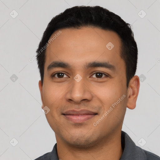 Joyful latino young-adult male with short  black hair and brown eyes