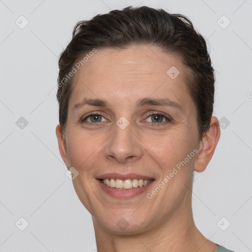 Joyful white adult female with short  brown hair and brown eyes