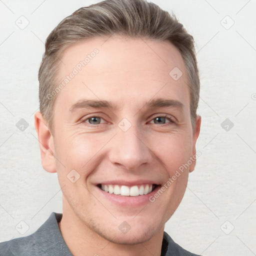 Joyful white young-adult male with short  brown hair and grey eyes