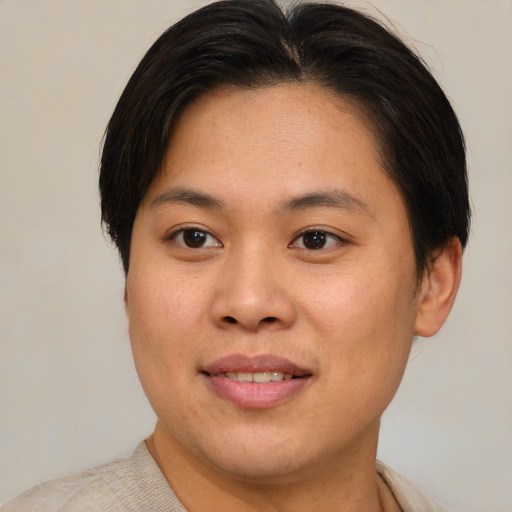Joyful asian young-adult female with short  brown hair and brown eyes