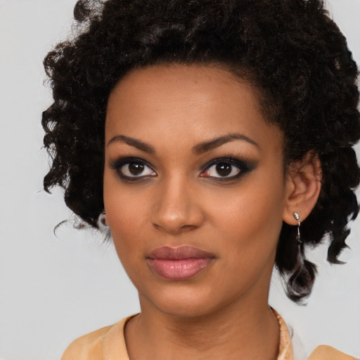 Joyful black young-adult female with medium  black hair and brown eyes