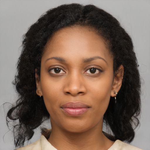 Joyful black young-adult female with long  black hair and brown eyes