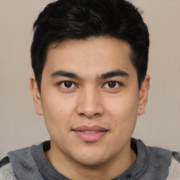 Joyful latino young-adult male with short  brown hair and brown eyes