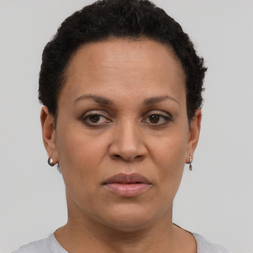 Joyful latino adult female with short  brown hair and brown eyes