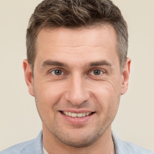 Joyful white adult male with short  brown hair and brown eyes