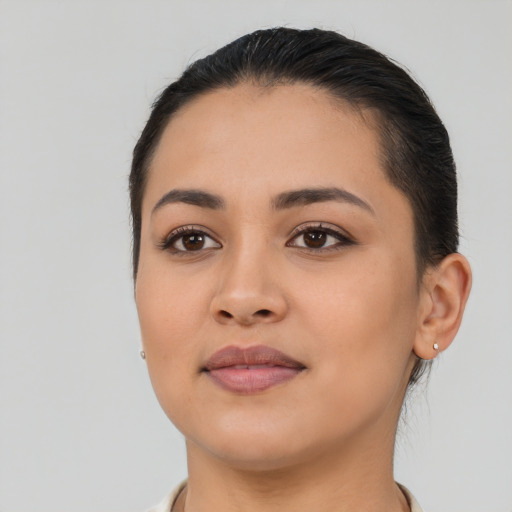 Joyful latino young-adult female with short  brown hair and brown eyes