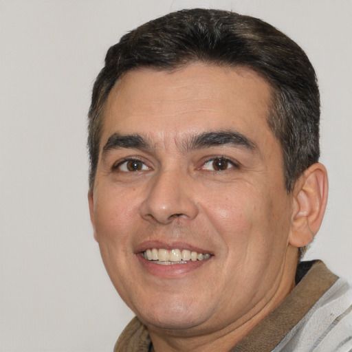 Joyful white adult male with short  brown hair and brown eyes