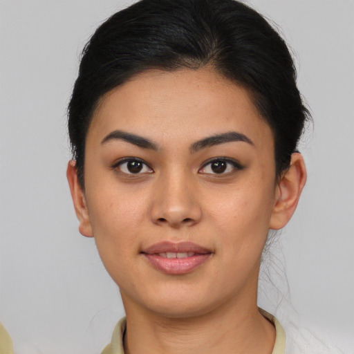 Joyful asian young-adult female with short  brown hair and brown eyes