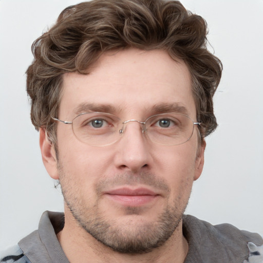 Joyful white adult male with short  brown hair and grey eyes