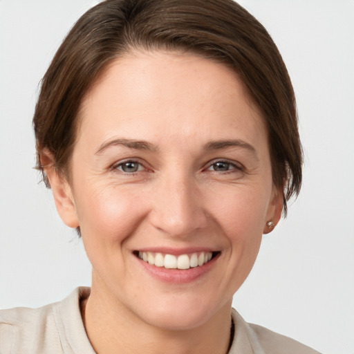 Joyful white young-adult female with short  brown hair and brown eyes