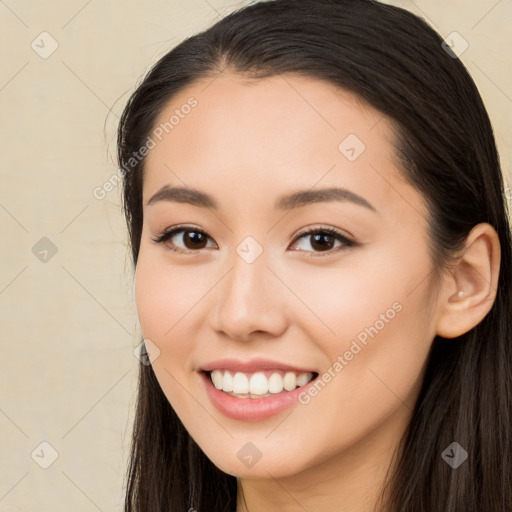 Joyful white young-adult female with long  brown hair and brown eyes