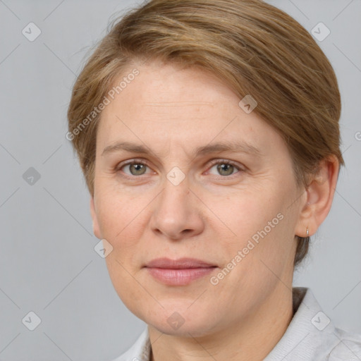 Joyful white adult female with short  brown hair and grey eyes