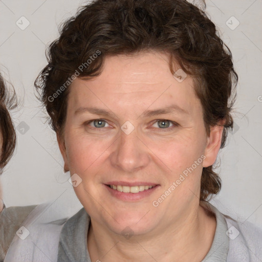 Joyful white adult female with medium  brown hair and blue eyes