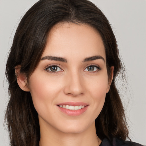 Joyful white young-adult female with long  brown hair and brown eyes