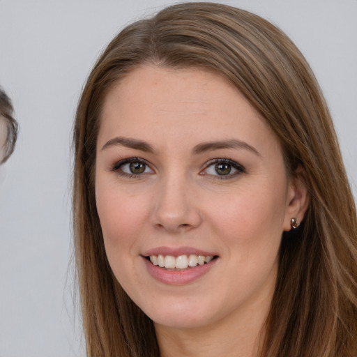 Joyful white young-adult female with long  brown hair and brown eyes