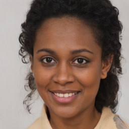 Joyful black young-adult female with medium  brown hair and brown eyes