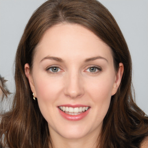 Joyful white young-adult female with long  brown hair and brown eyes