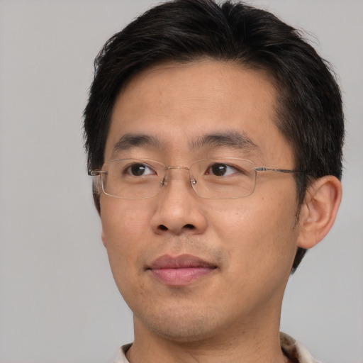 Joyful asian adult male with short  brown hair and brown eyes