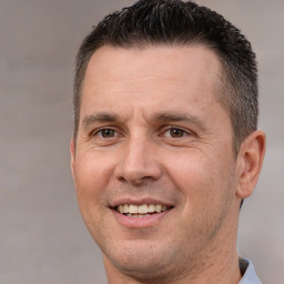 Joyful white adult male with short  brown hair and brown eyes