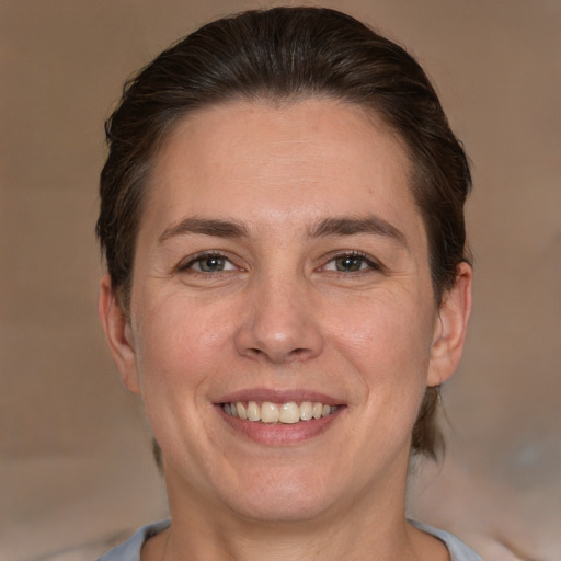 Joyful white adult female with short  brown hair and brown eyes