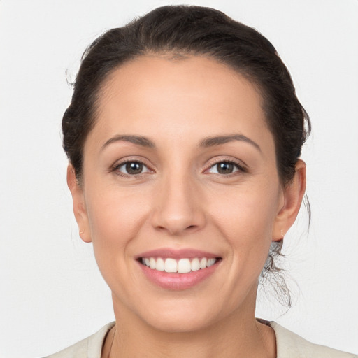 Joyful white young-adult female with medium  brown hair and brown eyes