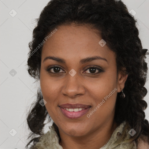 Joyful black young-adult female with long  brown hair and brown eyes