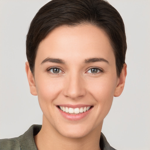 Joyful white young-adult female with short  brown hair and brown eyes