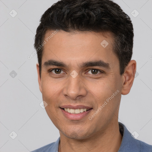 Joyful white young-adult male with short  black hair and brown eyes