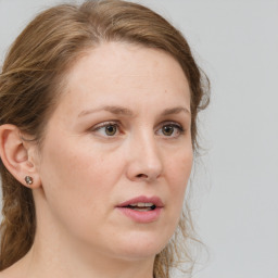 Joyful white adult female with medium  brown hair and grey eyes