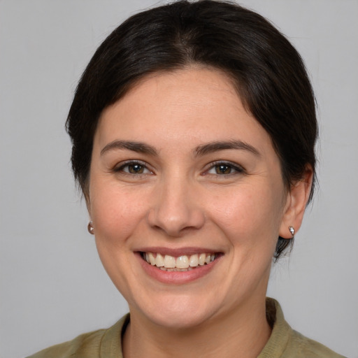 Joyful white young-adult female with medium  brown hair and brown eyes