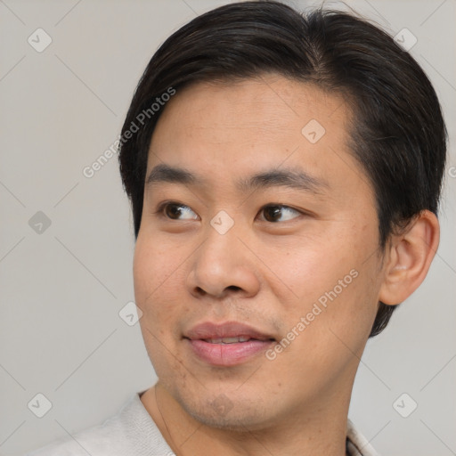 Joyful asian young-adult male with short  brown hair and brown eyes